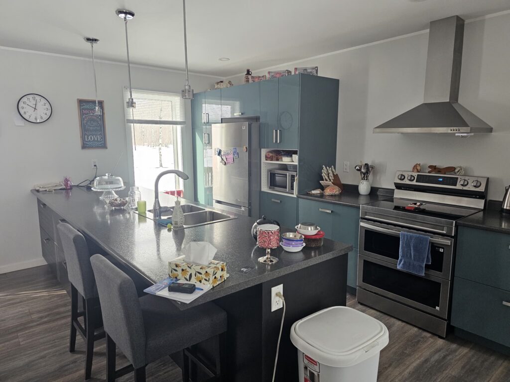 Finished kitchen renovation with blue cabinets and island